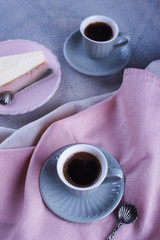 Cheesecake and black coffee and a small cup