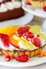Colorful cupcakes with fresh fruits.