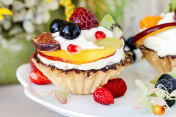 Colorful cupcakes with fresh fruits.