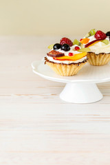 Colorful cupcakes with fresh fruits.