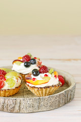 Colorful cupcakes with fresh fruits.