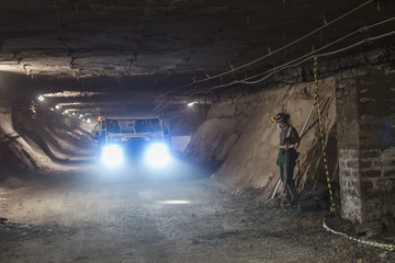Miner in exploitation hollow looks at a passing car in cooper mine.