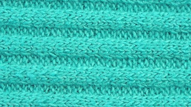 Textile background - blue cotton fabric with jersey (ribbing) structure. Weave pattern of threads close up. Macro shoot.