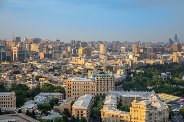 Fototapeta na wymiar Overview panorama of central city business district and residential suburbs in sunset rays, Baku, Azerbaijan
