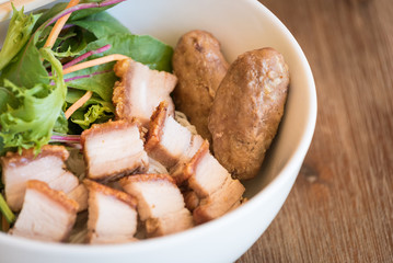 The full bowl with roasted pork belly, sugarcane prawn, rice vermicelli and vegetables, served with fish sauces, one of traditional Vietnamese food, famous and popular.