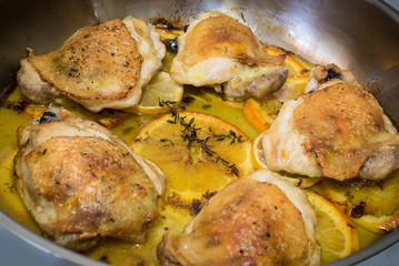 Pan roasted citrus chicken with butter, lemon, navel orange, thyme, rosemary, salt and pepper. Healthy food. Delicious meal.