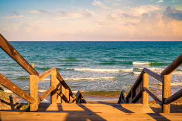 wooden stairs over the dunes to go down to the beach