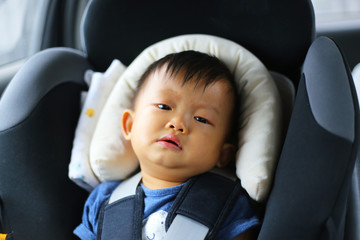 Asian baby crying in car seat. Boy unlike to sit in car seat.