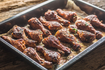 Roasted chicken legs barbecue in baked pan - Close-up