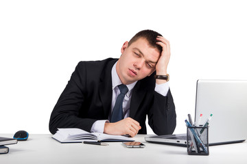 Office, finances, internet, business, success and stress concept-Frustrated young businessman working on laptop computer at office