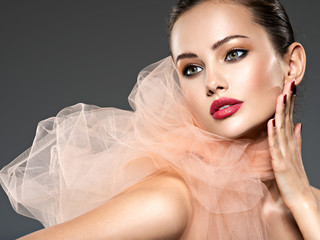 closeup face of a fashion woman with stylish makeup, red nails and lips