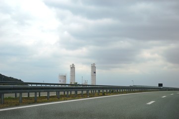 Obraz premium factory chimneys by the side of the road