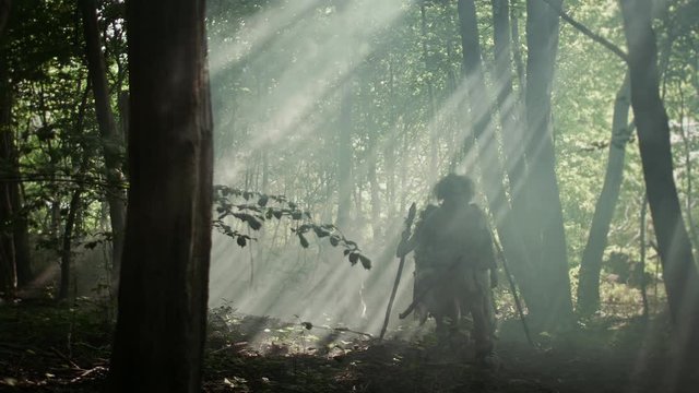 Tribe of Hunter-Gatherers Wearing Animal Skin Holding Stone Tipped Tools, Explore Prehistoric Forest in a Hunt for Animal Prey. Neanderthal Family Hunting in the Jungle or Migrating for Better Land