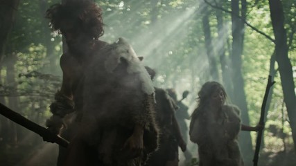 Tribe of Hunter-Gatherers Wearing Animal Skin Holding Stone Tipped Tools, Explore Prehistoric Forest in a Hunt for Animal Prey. Neanderthal Family Hunting in the Jungle or Migrating for Better Land