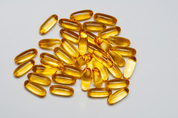 Close up of food supplement oil filled capsules suitable for: fish oil, omega 3, omega 6, omega 9, evening primrose, borage oil, flax seeds oil, vitamin A, vitamin D, vitamin D3, vitamin E.	