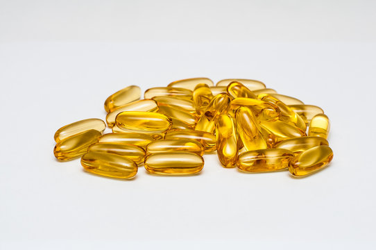 Close up of food supplement oil filled capsules suitable for: fish oil, omega 3, omega 6, omega 9, evening primrose, borage oil, flax seeds oil, vitamin A, vitamin D, vitamin D3, vitamin E.	