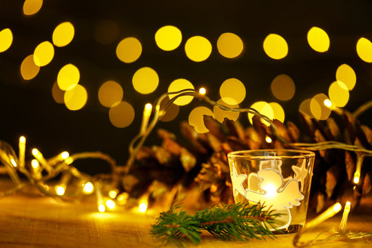 christmas theme with candles, snow, .pinecone and christmas light with pokeh effect
