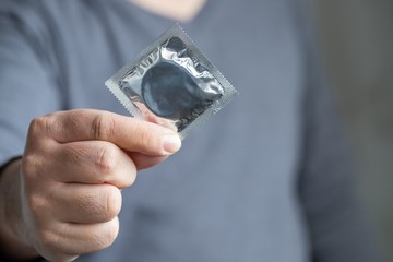 Image of a man using a condom