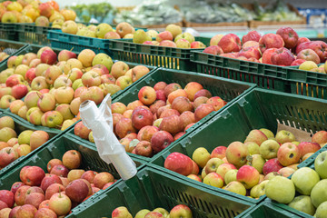 Apples in a boxes on a grocery food store background.
