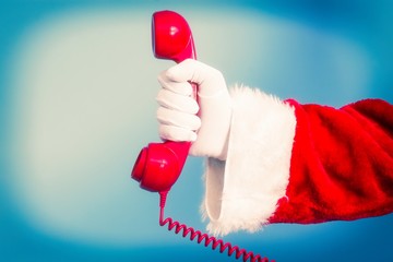 Santa Claus holding red phone