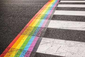 Rainbow markings on the pavement at a pedestrian crossing - rights of the LGBT community - gay...