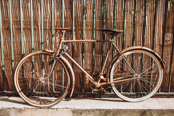 Fototapeta na wymiar Old vintage old style bike at the fence