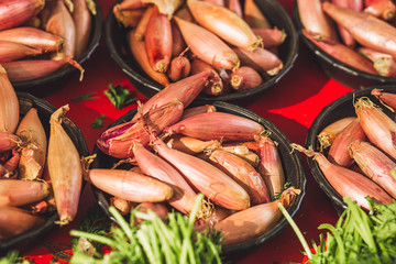 Closeup of fresh small oblong bulbs - fruit rural market