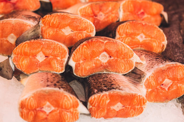 Closeup fresh steaks of red fish - salmon - fruit rural market