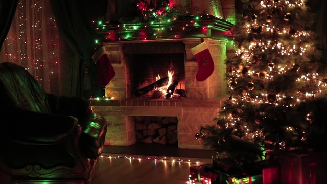 Christmas tree decorated in living room interior with fireplace, armchair, window