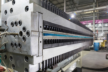 Plastic polycarbonate hollow sheet extrusion die with sheet line. Industrial photos of factory translucent structures