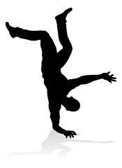 A male street dance hip hop dancer in silhouette