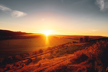 Idyllic relaxed sunset view from a view point and watching colorful sunset light and country side valley landscape. Enjoy a beautiful evening sunny day. Teufelsmauer, Thale Harz National Park, German 