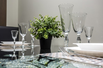 banquet table served with instruments and decorated with empty wine glasses