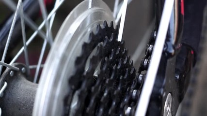 masters, lubricate the bicycle chain of a mountain bike with a special lubricant in the home workshop. Cleaning and lubricating the bicycle chain and gearbox with oil spray close up selective focus
