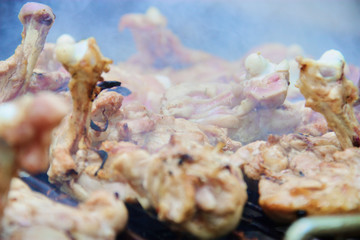 Obraz na płótnie Canvas Close up raw chicken on the grill with smoke.