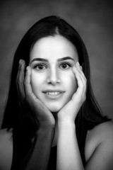 Fototapeta premium Woman keeping dark skin and caucasian hands on face portrait