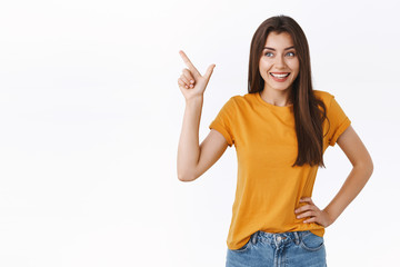 Coquettish silly happy woman in yellow t-shirt, giggle thrilled and amused as checking out amazing...