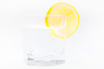 Slice of lemon on the glass isolated on the white