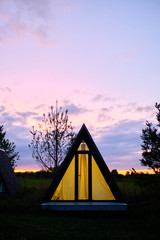 wigwams against the sunset sky. A hause
