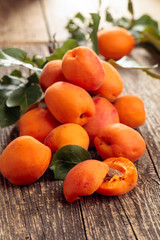 Naklejka na ściany i meble Fresh apricots on a old wooden table.