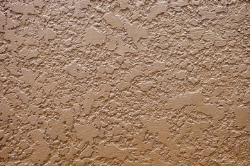 Brown Stucco Texture Wall Background with Light Leak from the Top.