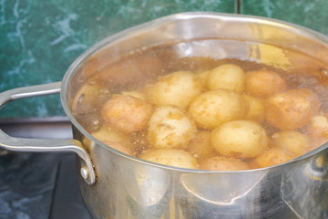 New potatoes boil in their skins in a saucepan