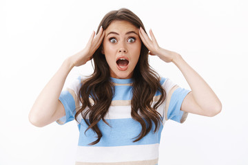 Shocked panicking woman hear mind-blowing news, look worried and shocked,stare camera touch temples...