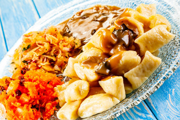 Potato noodles - dumplings on wooden background