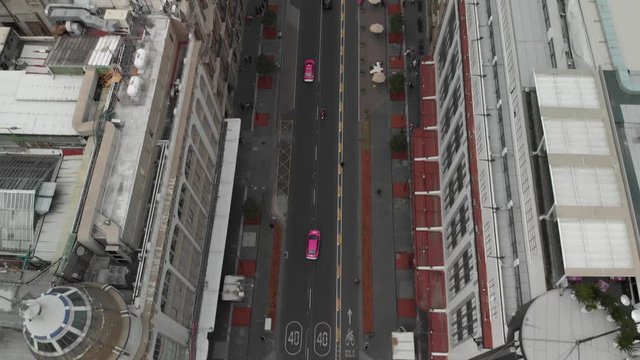 Aerial reveal type shot of Mexico City main square, El Zocalo, drone hovering in 20 de noviembre and tilting up slowly.