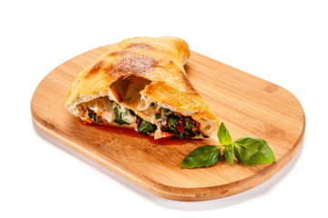 Pizza calzone on cutting board on white background