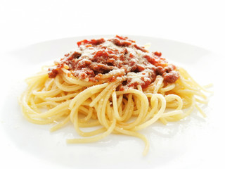 Spaghetti Bolognese with minced beef, onion, chopped tomato, garlic, olive oil, stock cube, tomato puree and Italian herb. Traditional Italian food in a white plate.