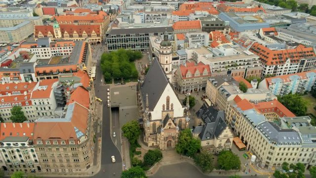 Aerial View of Old Town in Leipzig, Germany, Europe. Scenic Cityscape and Skyline from above (bird's-eye view) with St. Thomas Church (Thomaskirche). 4K Background Drone Panning Shot