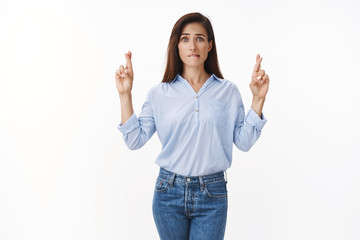 Nervous cute worried adult woman with tattoo arm, bite lip anxious, cross fingers good luck, willing win lottery, concerned awaiting important result, praying fortune, supplicating white background