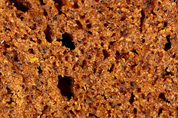 Black rye bread as an abstract background